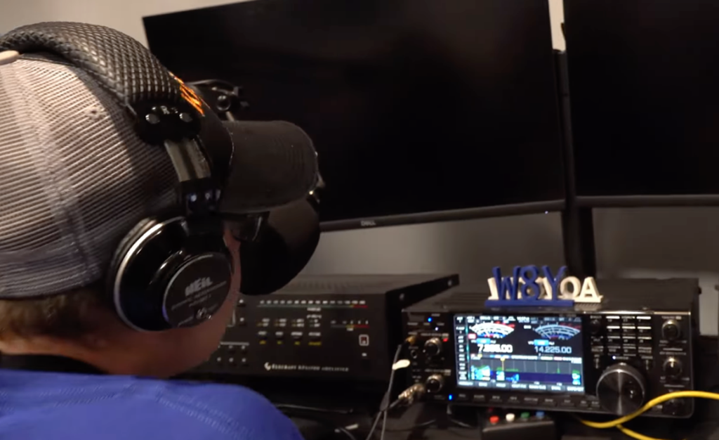 young ham operator at radio controls