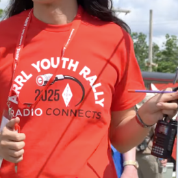 young woman holding a ham radio antenna
