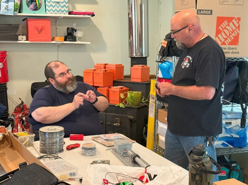 men prepping antenna components