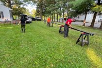 men assembling an antenna mast on sawhorses