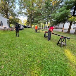 men assembling an antenna mast on sawhorses