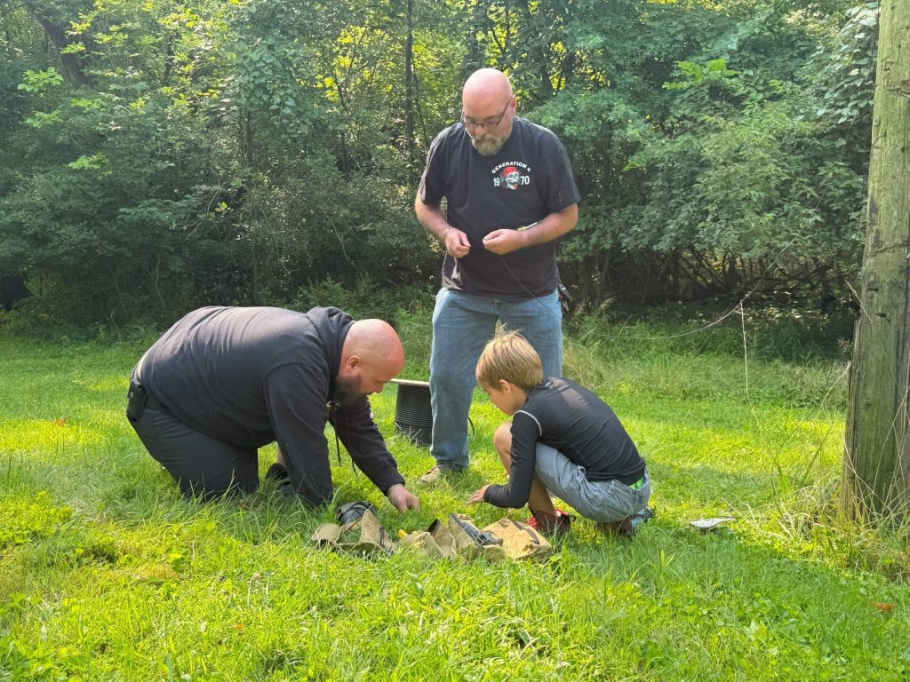 men assembling radial wires for an antenna