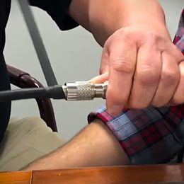man wrapping an RF connector with tape