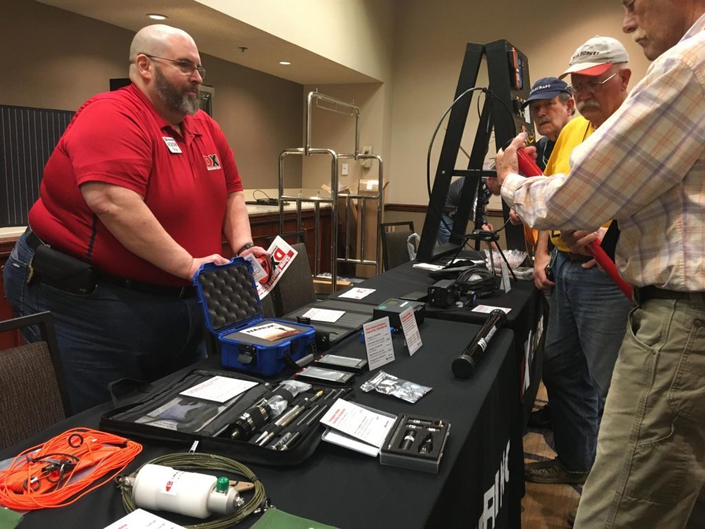 man behind a trade show radio table