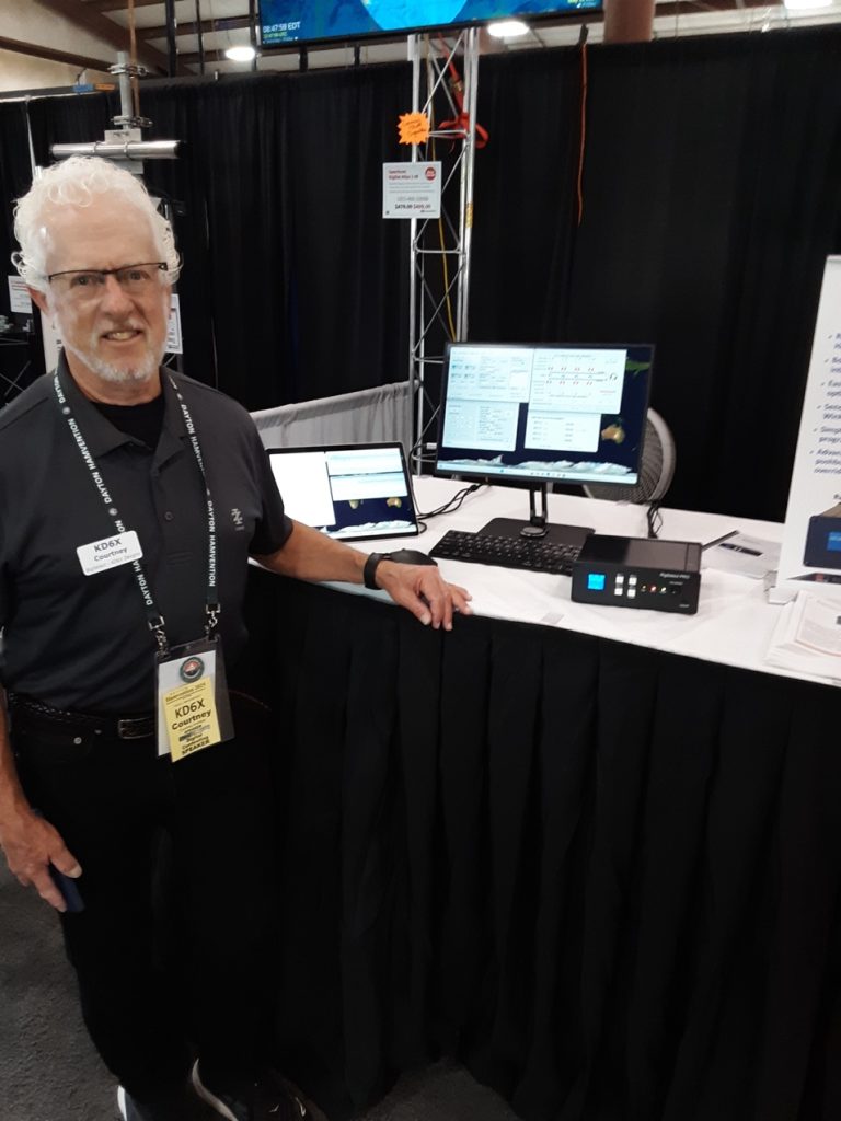 man standing at a trade show table