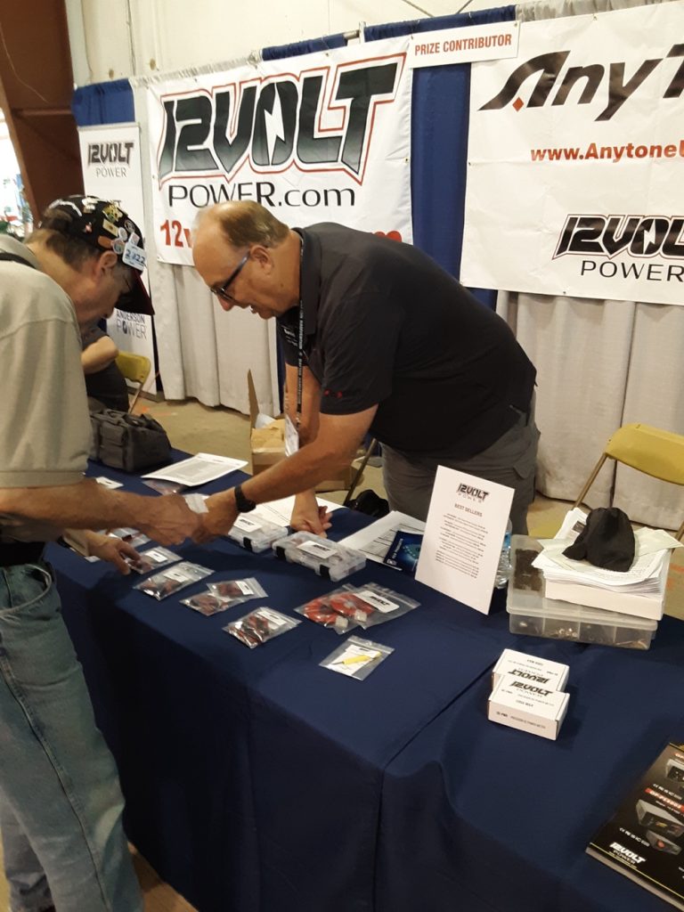 man working with a customer at a trade show booth