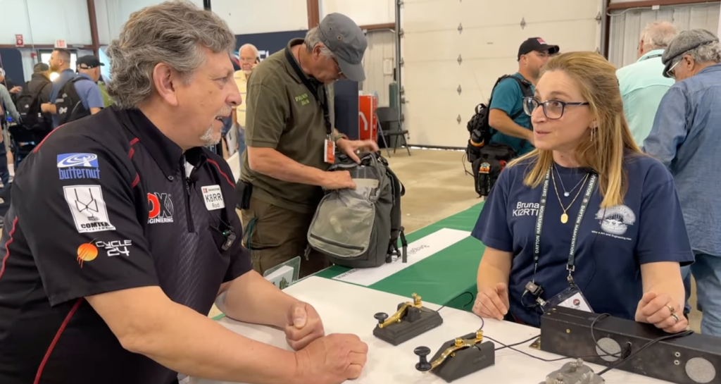 man and woman speaking at a trade show