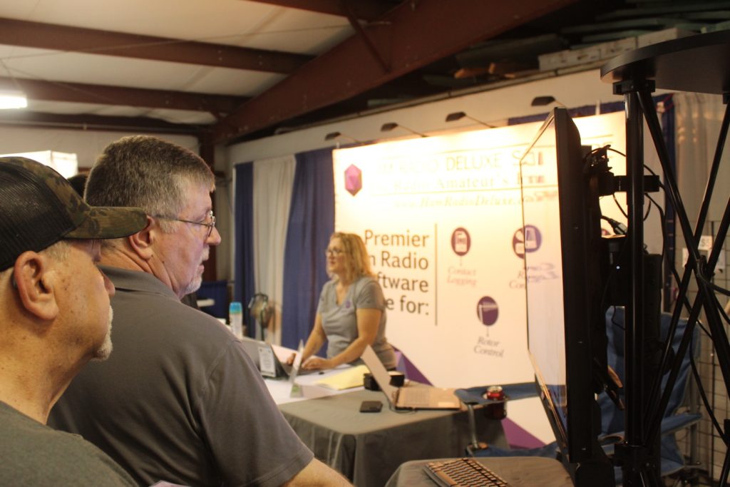 men watching video display at a trade show