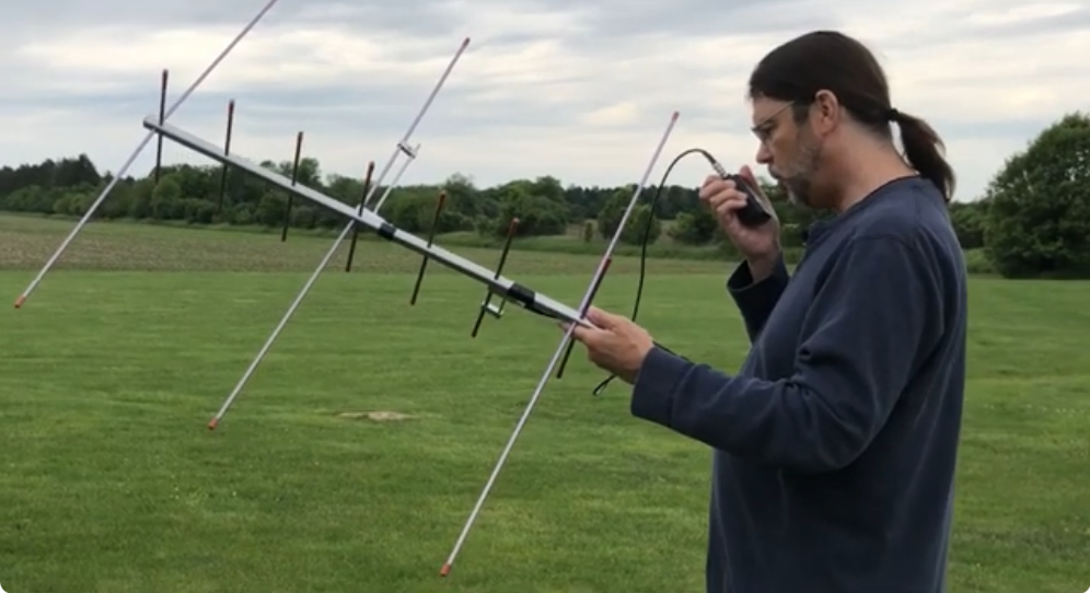 man holding a portable yagi antenna