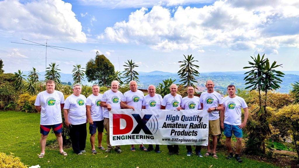 group of ham radio operators holding a banner outside