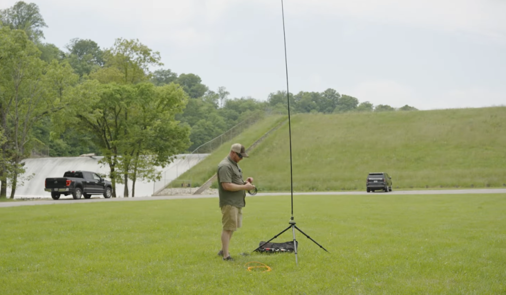 Man installing a larger portable vertical antenna