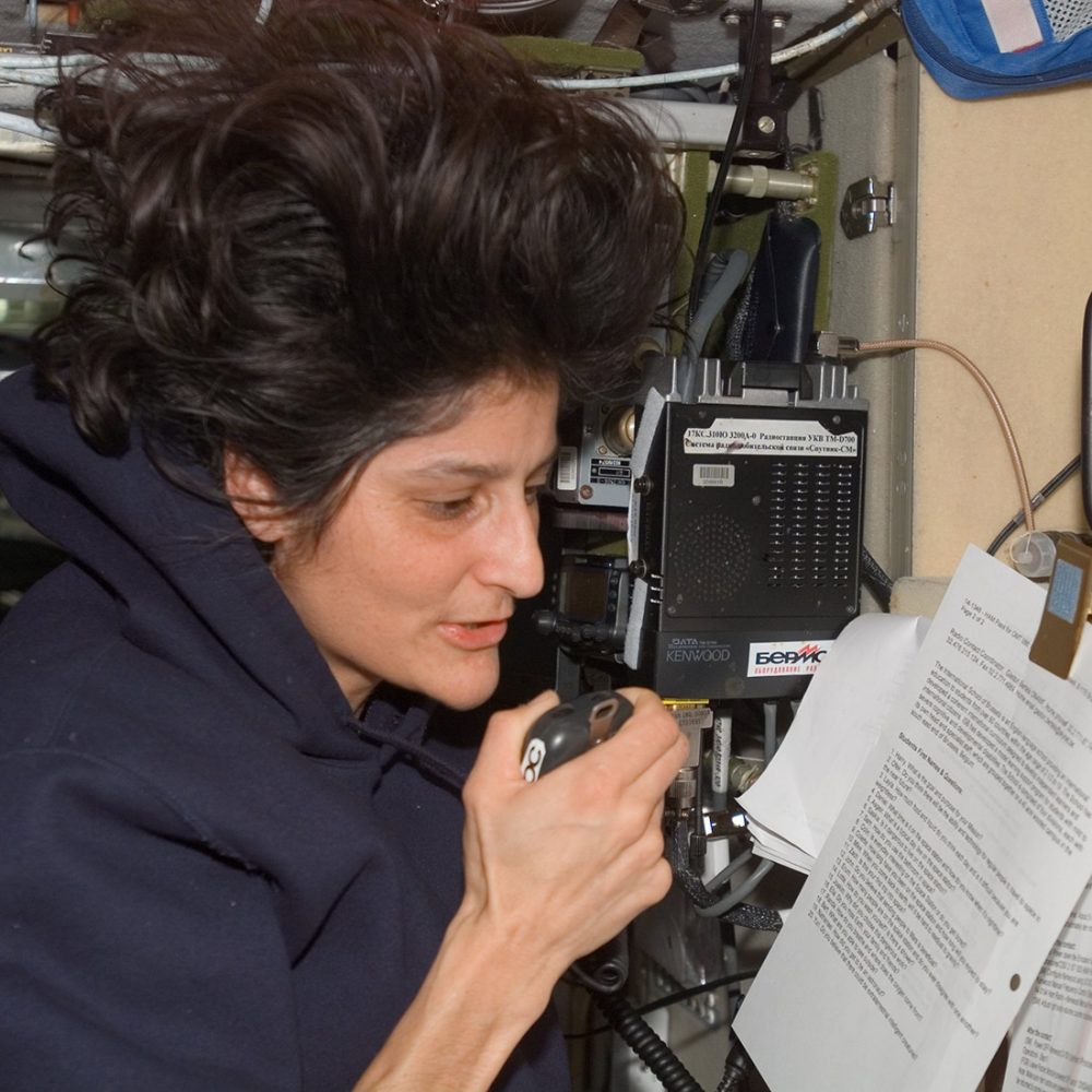 astronaut speaking into a radio microphone from space