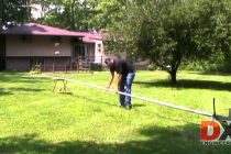 Man erecting a large vertical antenna