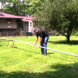 Man erecting a large vertical antenna