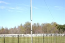 vertical ham radio antenna erected in field