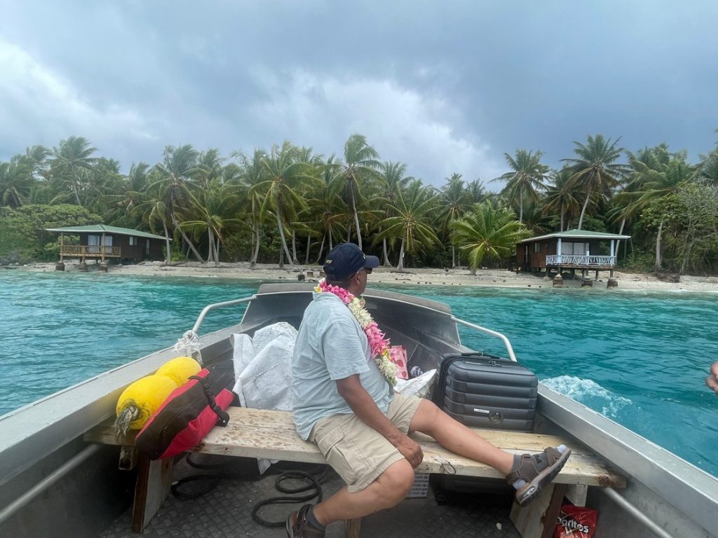 man sitting in bow of a small boat