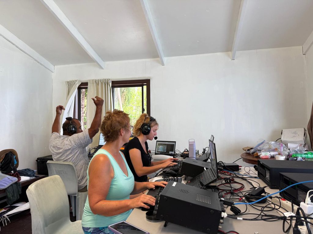 ham radio operators sitting in front of radios