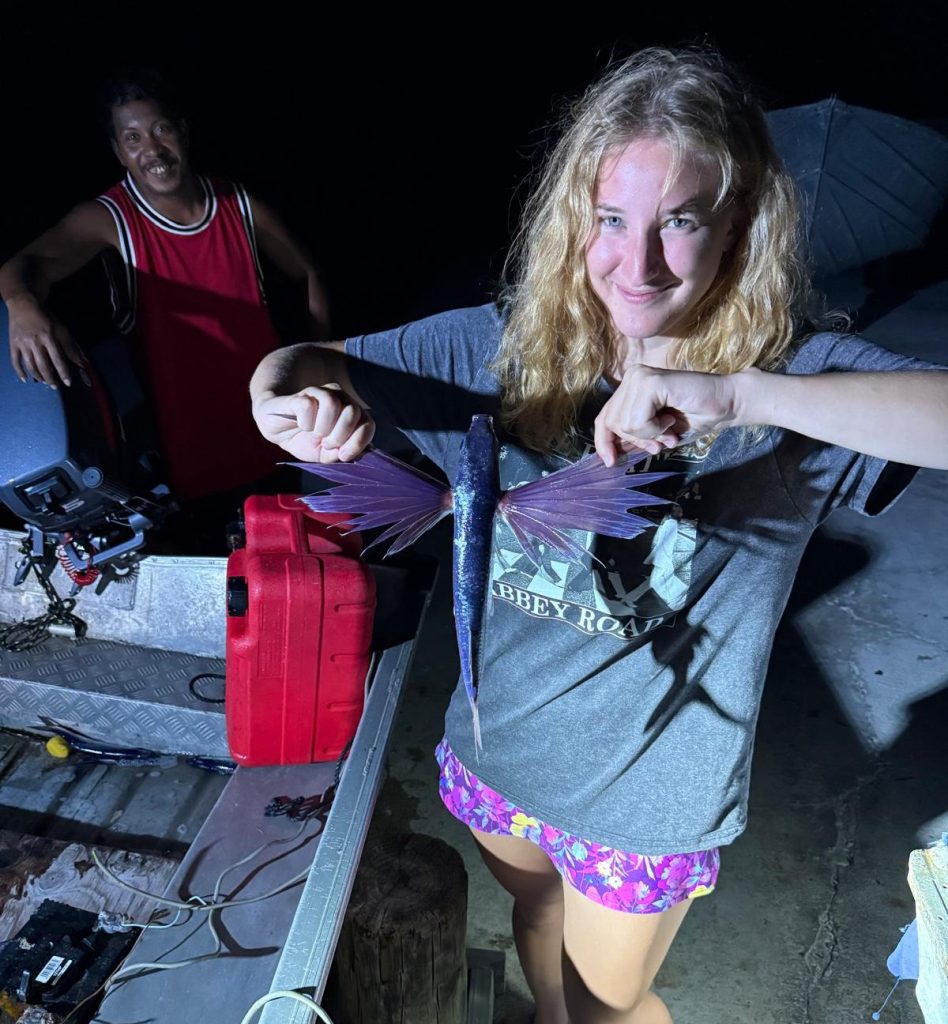 woman holding up an exotic fish