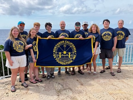 young ham radio operators holding a banner