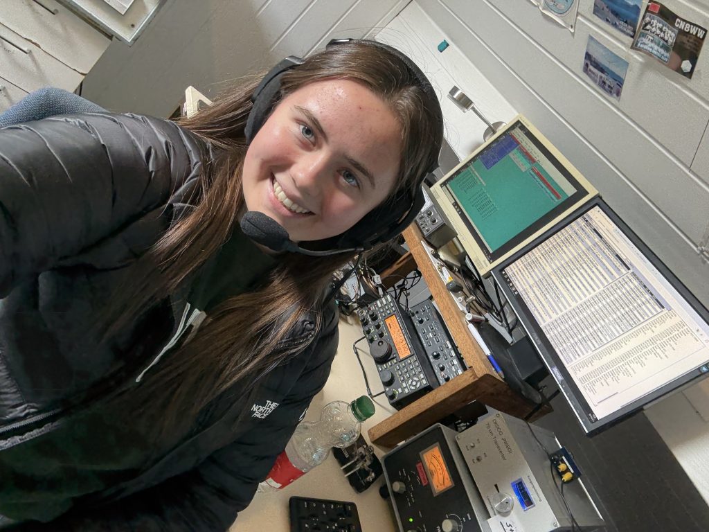 Young ham radio operator at station controls