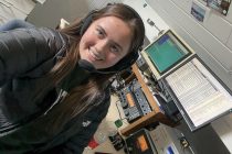 Young ham radio operator at station controls
