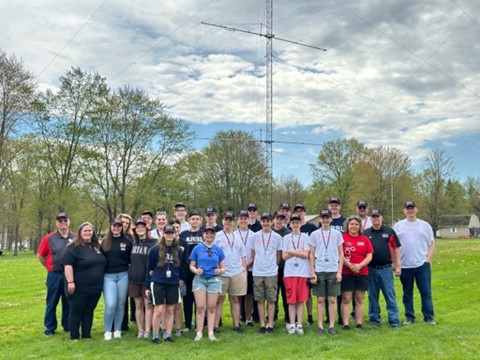 Group of tech school students outside near antenna